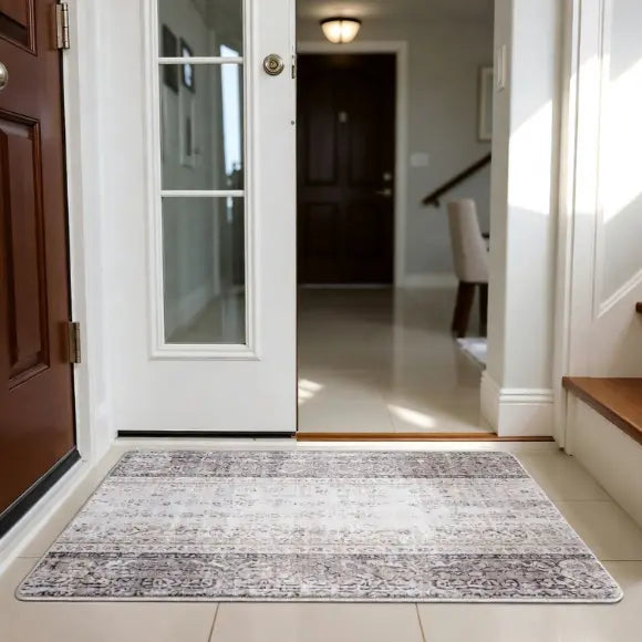 Decorative rug on a tiled floor in a home entrance